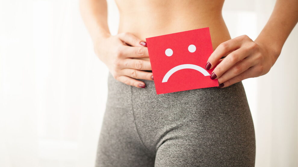Vaginal urinary infection problems concept young woman holds paper with sad smile crotch 990x556
