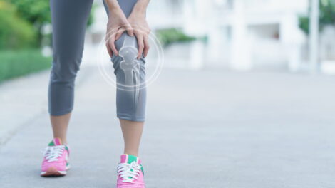 Woman holds her hands knee pain knee medicine massage concept 470x264