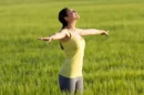 Beautiful young woman enjoying spring standing cereal field jpg 130x86