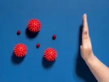 Flat lay hand stopping viruses jpg 215x161