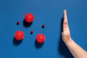 Flat lay hand stopping viruses jpg 300x200