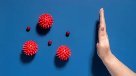 Flat lay hand stopping viruses jpg 470x264