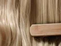 Woman s hand with bright manicure running through long wavy blond hair jpg 215x161