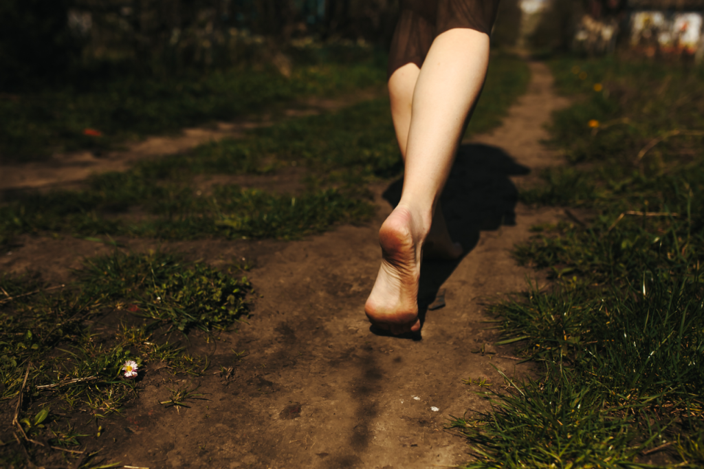 Close up bare feet ground 1024x682