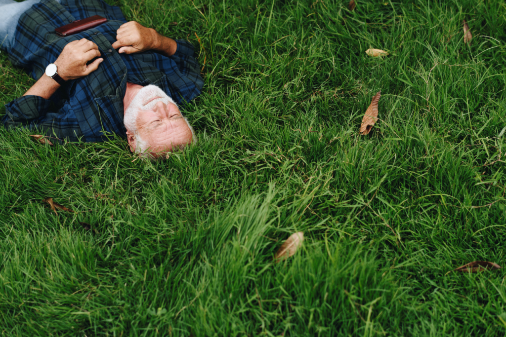 Elderly man sleeping green grass 1024x683