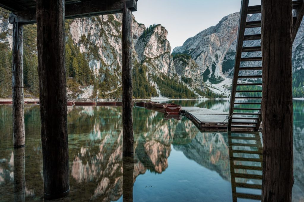 High rocky mountains reflected braies lake with wooden stairs near pier italy 1024x683