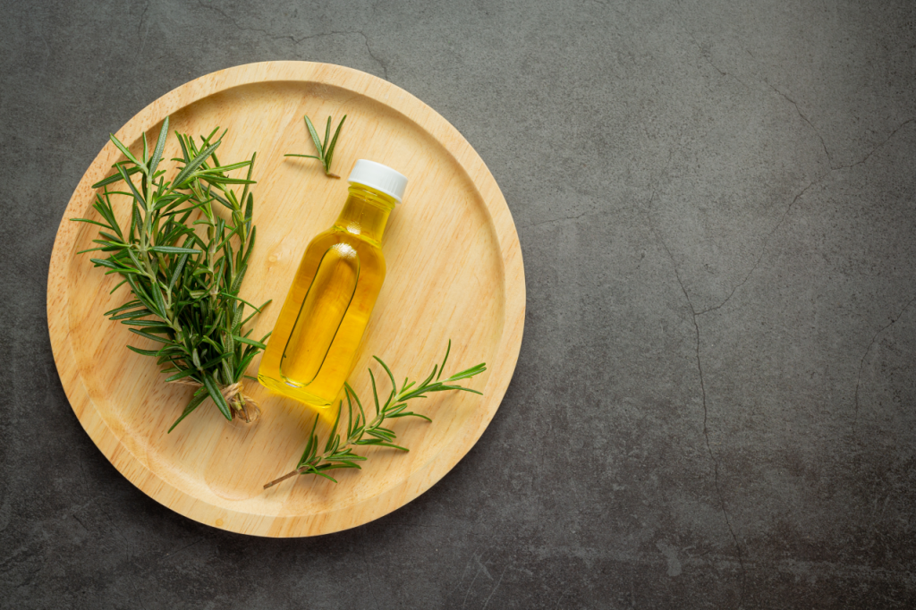 Rosemary oil bottle with rosemary plants 2 1024x682