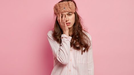 Young woman wearing pajamas sleep mask 470x264