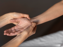 Close up hands massaging wrist 215x161