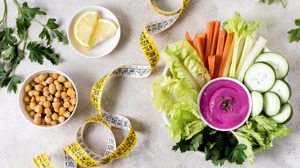 Flat lay vegetables with chickpeas measuring tape 990x556