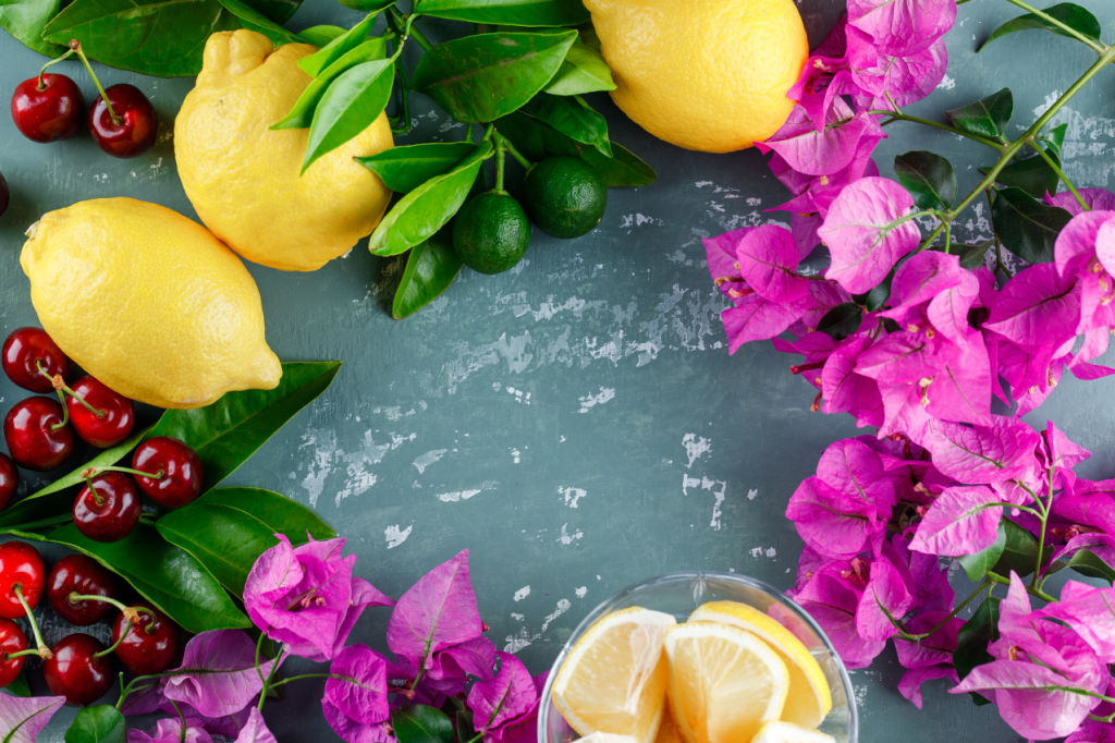 Lemons with leaves slices flowers cherries plaster surface 1024x682