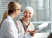 Middle aged woman with skin cancer talking with her doctor 74x55