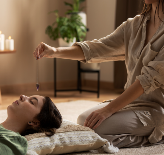 Person conducting reiki therapy 550x520
