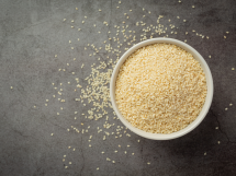 Sesame seeds bowl dark background 215x161