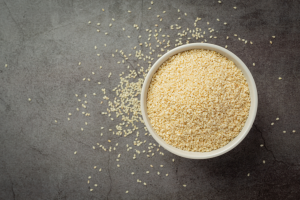 Sesame seeds bowl dark background 300x200