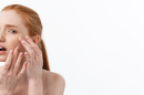 Young caucsian woman squeezes acne face beauty 130x86