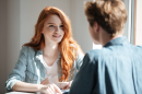 Young female student listening her friend 130x86