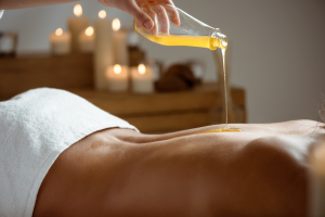 Honey pouring woman s naked back spa salon 300x200