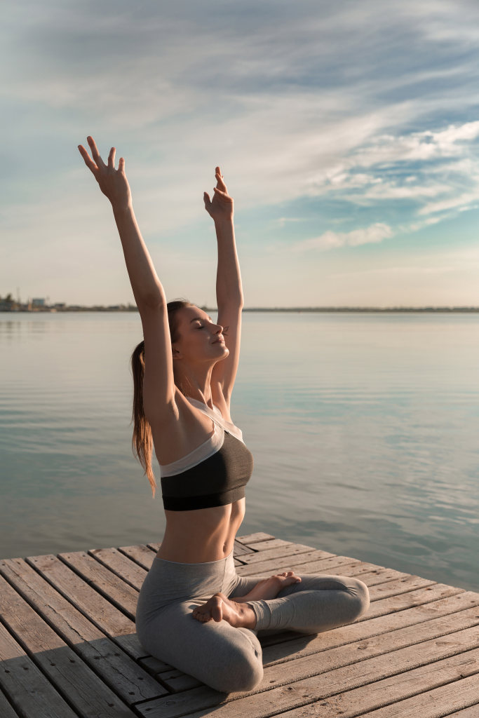 Sports lady beach make meditate exercises 683x1024