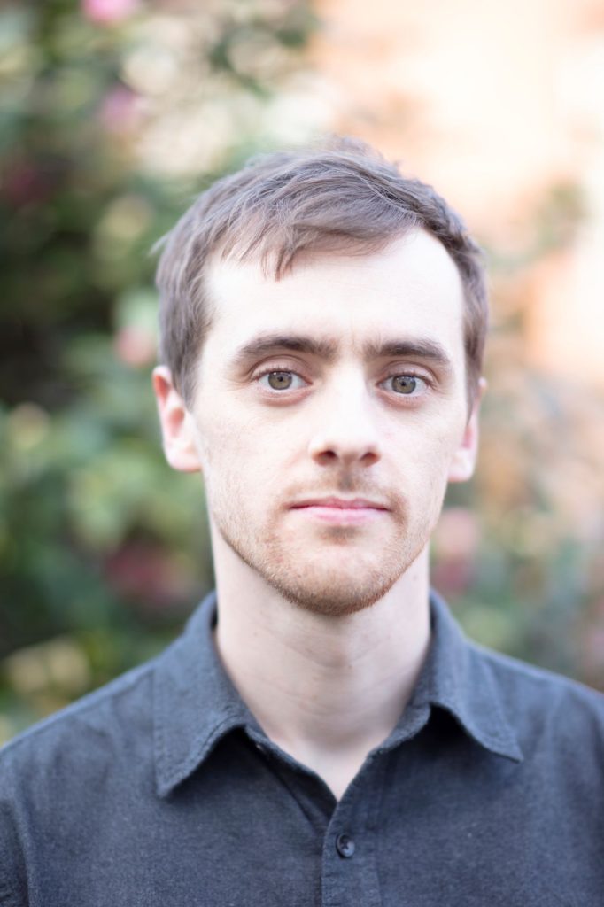 Liam Shaw headshot grey shirt 1 682x1024