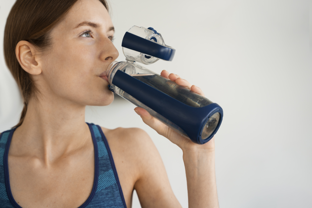 Front view woman drinking water 1024x683