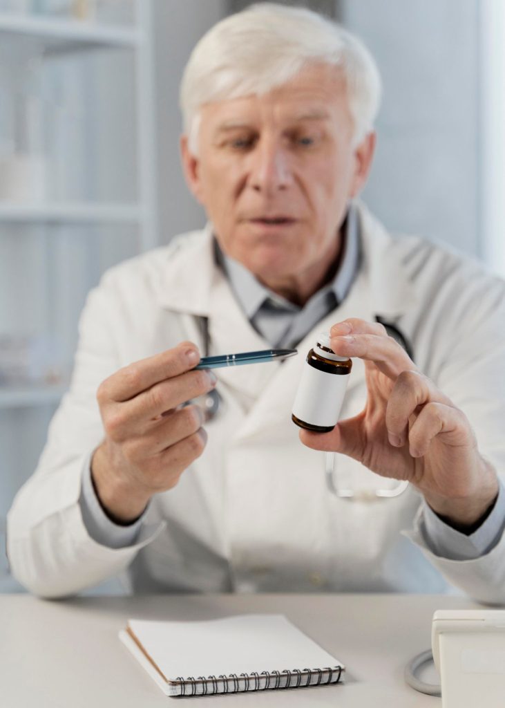 Old male doctor his office 731x1024