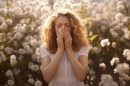Woman suffering from allergy by being exposed flower pollen outside 130x86