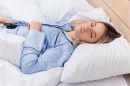 Young beautiful woman blue pajamas laying bed 130x86
