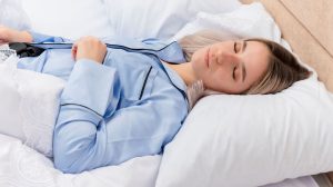 Young beautiful woman blue pajamas laying bed 300x168