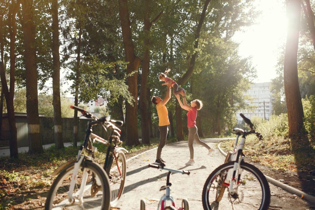 Family with bicycle summer park 1024x682