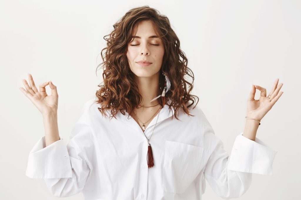 Stylish young woman meditating practice yoga breathing 1024x682
