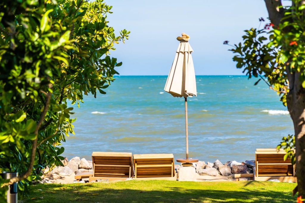 Beautiful outdoor nature landscape with bed deck chair around swimming pool hotel resort 1024x682