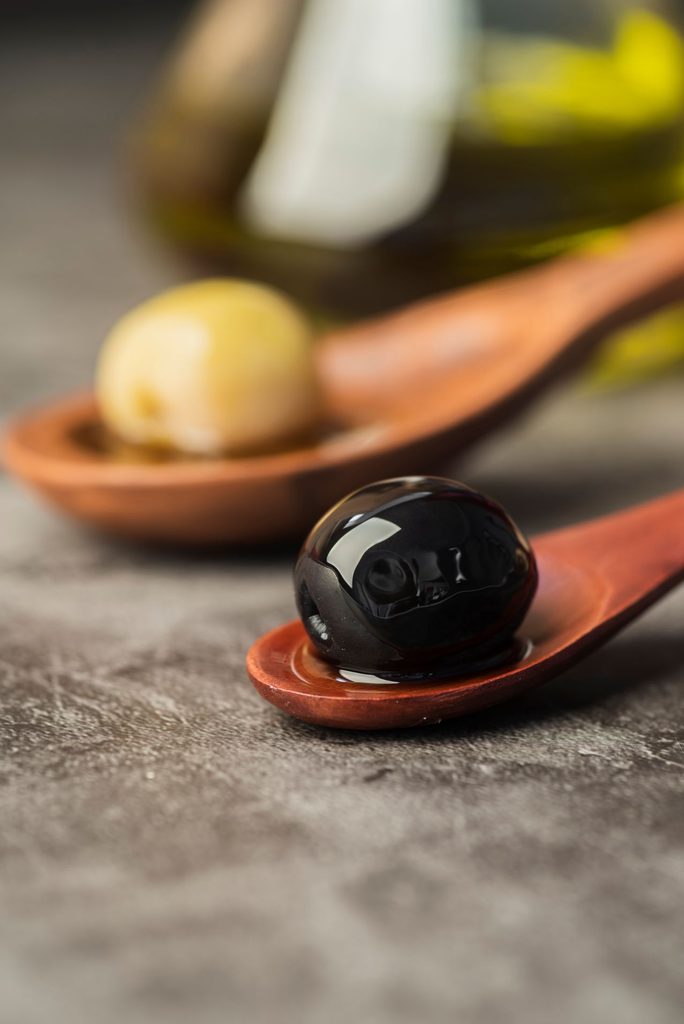Close up organic olives spoon 684x1024